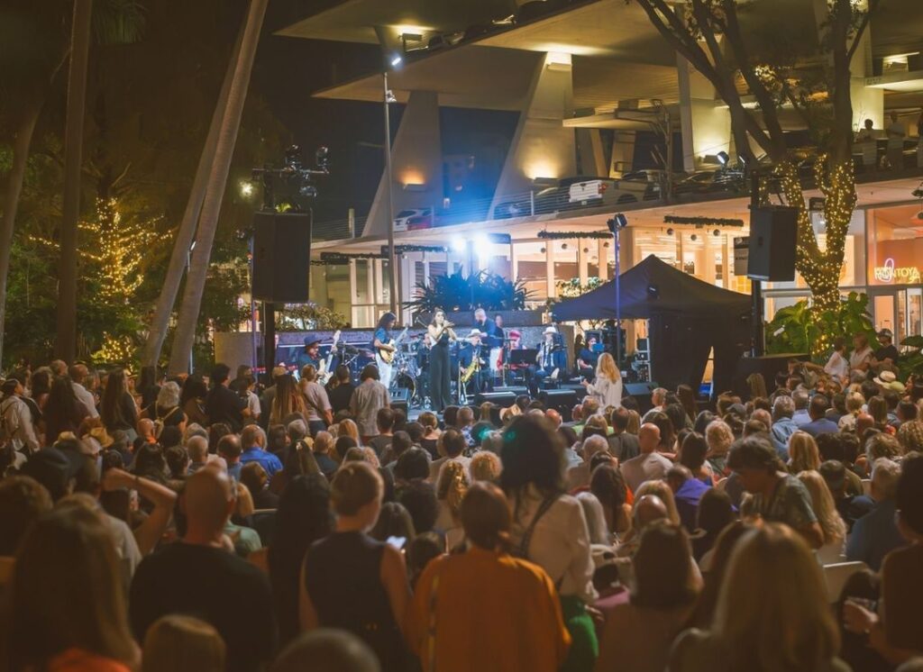 Large crowd watching a live jazz performance at night during the South Beach Jazz Festival on Lincoln Road in Miami Beach