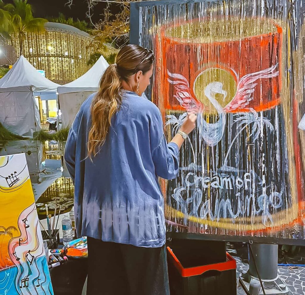 Artist painting a colorful jazz inspired artwork live during the South Beach Jazz Festival on Lincoln Road in Miami Beach