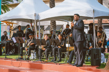 Band members sit on the stage between songs at the Jazz for Tomorrow Stage