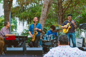 Russ Spiegel and the other group members perform at the Power Access Main Stage